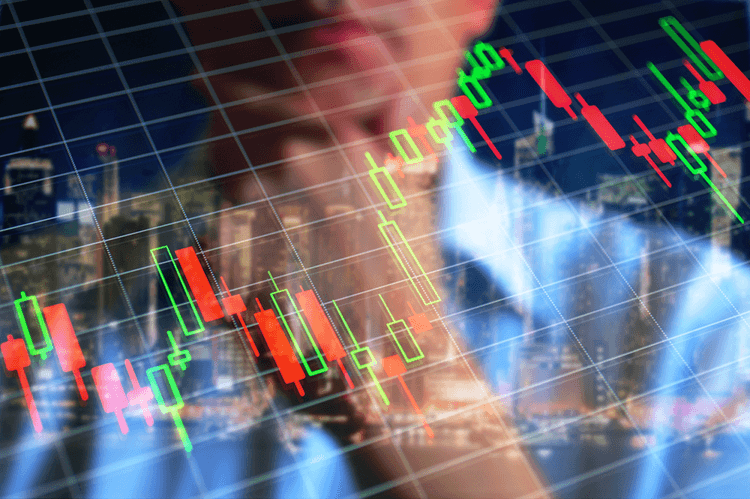 Man looking at candlestick chart