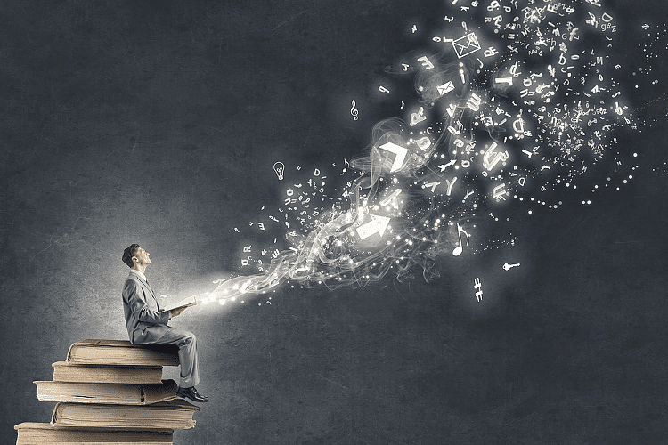 Man sitting on stack of trading books